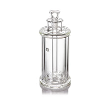 A clear, cylindrical borosilicate glass jar with a fitted lid and small top handle appears against a white background, featuring a logo inspired by the MJ Arsenal Piston Gravity Bong on the front.