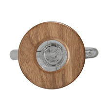 Top view of a clear glass teapot with a round wooden lid and glass handle, inspired by the sleek design of the MJ Arsenal Alpine Series - Apex Mini Rig, photographed against a white background.