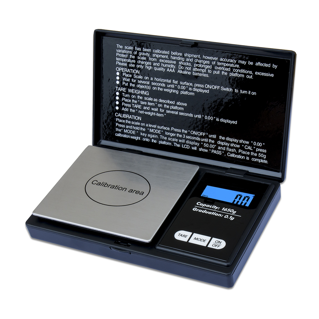 The WeighMax 3805 Scale has a stainless steel weighing platform, Calibration area label, blue back-lit LCD, and measures in 0.01g increments. Instruction text is printed inside the open lid above the scale.