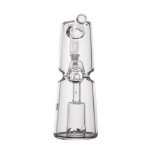 The MJ Arsenal Turret Mini Dab Rig features clear borosilicate glass, a cylindrical base, central chamber, and angled mouthpiece. Photographed on a white background, this portable rig combines a clean design with lasting durability.