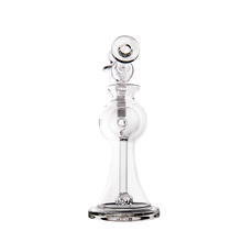 The MJ Arsenal Apollo Mini Dab Rig is shown against a white background, featuring clear borosilicate glass with a wide rounded base, straight neck, circular mouthpiece, multiple chambers for flavor preservation, and intricate glasswork.