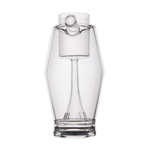 The MJ Arsenal Proxy Bubbler is a clear borosilicate glass pitcher with a unique design featuring an internal element like an inverted wine glass. Shown against a plain white background, it's ideal as a stylish dabbing accessory or Proxy Bubbler.