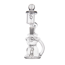 The MJ Arsenal Hydra Mini Dab Rig is a clear glass recycler water pipe with a unique design featuring multiple chambers and curved elements, shown on a plain white background.