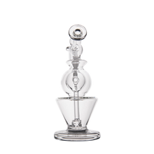 The MJ Arsenal Gemini Mini Dab Rig is a clear borosilicate glass water pipe with a rounded chamber, vertical neck, and flared base, shown upright against a plain white background.