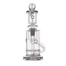 The MJ Arsenal Ursa Mini Dab Rig, made of clear borosilicate glass, has a cylindrical base, curved side tube, vertical chamber, and spherical top piece, all displayed on a plain white background.