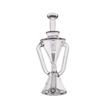 The MJ Arsenal Time Turner Mini Dab Rig is made from clear borosilicate glass and features a cylindrical top, funnel-shaped middle, conical base, intricate internal tubing, and symmetrical side arms for a scientific look.