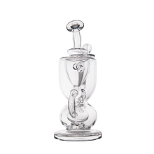 The MJ Arsenal Titan Mini Dab Rig, made of clear borosilicate glass with a round base, vertical chamber, curved mouthpiece, and detachable bowl, is displayed against a plain white background.