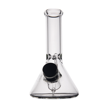 The MJ Arsenal Cache Bong is a clear borosilicate glass beaker-style mini bong with a wide base, cylindrical neck, and black bowl piece on the front. Its compact design stands out against a plain white background.