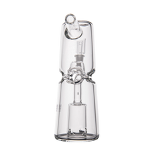 The MJ Arsenal Turret Mini Dab Rig, made from clear borosilicate glass with a cylindrical body, angled mouthpiece, and internal percolator for filtration, is photographed against a white background—compact and portable for dabbing.