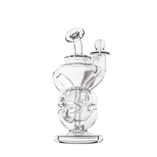 The MJ Arsenal Infinity Mini Dab Rig is a clear borosilicate glass piece with an intricate, curved design and multiple chambers, showcased against a plain white background.