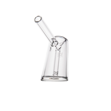 The MJ Arsenal Fulcrum Bubbler, made of clear borosilicate glass with a cylindrical body and angled spout, is shown on a plain white background.