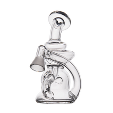 The MJ Arsenal Hydra Vape Edition is a clear glass mini dab rig with a curvy design, rounded base, bent neck, and angled mouthpiece. Splash-resistant for smooth hits, it is set against a plain white background.