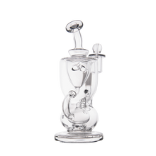 The MJ Arsenal Titan Mini Dab Rig, made of clear borosilicate glass, showcases intricate chambers, a wide round base, central percolator, and angled mouthpiece—capturing its elegance against a plain white background.