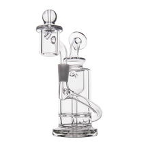 The MJ Arsenal Ursa Mini Dab Rig is made from clear borosilicate glass with a cylindrical base, bent neck, multiple chambers, and a domed banger attachment. It’s shown on a white background.
