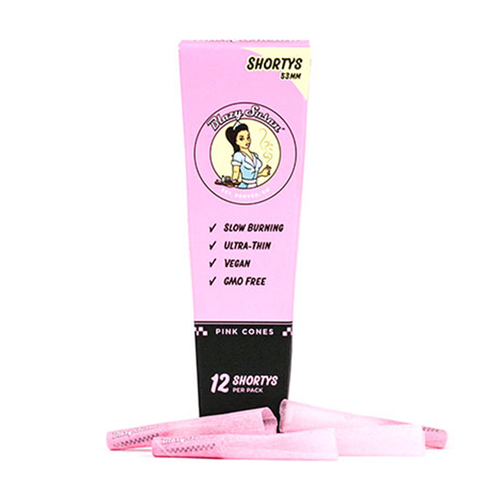 The Blazy Susan Pink Paper Cones come in a pink box labeled Shortys, containing 12 slow-burning, ultra-thin, vegan, GMO-free pre-rolled cones. Four pink cones are shown in front of the box.
