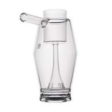 The MJ Arsenal Proxy Bubbler, made of clear borosilicate glass with a cylindrical spout, central chamber, and flared base, is shown against a plain white background.
