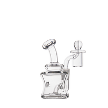 The MJ Arsenal Jammer Mini Dab Rig is a clear borosilicate glass piece with a curved mouthpiece, bent downstem chamber, and attached quartz banger with round carb cap—shown compactly against a plain white background.
