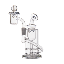 The MJ Arsenal Ursa Mini Dab Rig, made from durable borosilicate glass, features a clear cylindrical chamber, curved neck, dome-shaped attachment, and multiple glass tubes with smooth, modern lines against a white background.