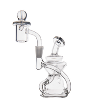 The MJ Arsenal Hydra Mini Dab Rig, a clear glass Klein recycler with a curved mouthpiece, cylindrical chamber, round base, and quartz banger, is elegantly showcased against a white background.