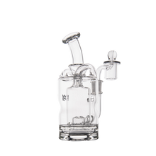 The MJ Arsenal Turbine Mini Dab Rig is a clear borosilicate glass water pipe with a cylindrical base, angled mouthpiece, and side percolator, shown on a plain white background.