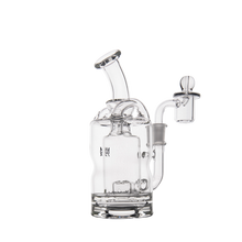 The MJ Arsenal Turbine Mini Dab Rig is a clear borosilicate glass water pipe featuring a bent mouthpiece, cylindrical chamber, and side percolator, shown against a white background.