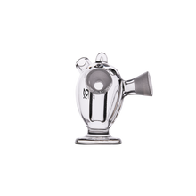 The MJ Arsenal Dubbler Original Double Bubbler features clear borosilicate glass, a wide base, two circular openings on top, and a slanted spout—perfect for smooth water filtration. Shown against a plain white background.