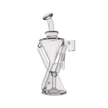 The MJ Arsenal Time Turner Mini Dab Rig is a clear borosilicate glass water pipe featuring an hourglass-shaped chamber, angled mouthpiece, and side joint for accessories—perfectly displayed against a white background.