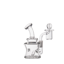 The MJ Arsenal Jammer Mini Dab Rig is a clear borosilicate glass water pipe with a bent mouthpiece, cylindrical base, detachable right chamber, and a small black logo on the front. The product is shown against a plain white background.