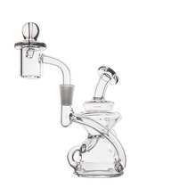 The MJ Arsenal Hydra Mini Dab Rig is a clear glass piece with a curved design, round base, angled neck, and side-mounted chamber topped with a dome-shaped carb cap, shown on a white background.