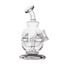 The MJ Arsenal Royale Vape Edition is a clear glass dab rig with a round base, curved mouthpiece, side opening, and sturdy flat bottom. Intricate internal designs are visible, all displayed against a white background.