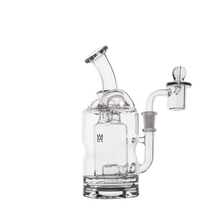 The MJ Arsenal Turbine Mini Dab Rig is a clear borosilicate glass water pipe with a cylindrical base, curved neck, attached bowl, and Inception Turbine Perc chamber. It stands upright on a white background with a small logo on the body.