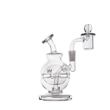 The MJ Arsenal Royale Mini Dab Rig is a clear borosilicate glass piece with a round base, angled mouthpiece, and attached bowl. Featuring a fab egg percolator in a modern scientific style, it’s ideal for concentrates and photographed on a white background.