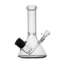 The MJ Arsenal Cache Bong features clear borosilicate glass, a beaker-style wide base, straight neck, removable right-side glass bowl, and a black-capped ash catcher on the left—ideal for durability and classic style.
