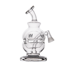 The MJ Arsenal Royale Vape Edition is a clear glass dab rig with a curved mouthpiece, round chamber, angled joint, decorative design, and sturdy circular base—ideal for fans of premium glassware.