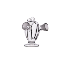 The MJ Arsenal Dubbler Original Double Bubbler is a clear borosilicate glass piece shaped like a small teapot with two open spouts and a rounded top handle, designed for smooth water filtration, shown on a plain white background.