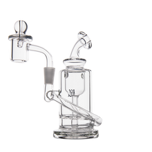 The MJ Arsenal Ursa Mini Dab Rig, crafted from durable borosilicate glass, has a clear cylindrical base, angled mouthpiece, side arm, and dome-shaped banger—all shown on a plain white background.