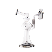 The MJ Arsenal Apollo Mini Dab Rig is a clear borosilicate glass rig with a wide base, curved neck, attached bowl piece, and percolator chamber. Its smooth, rounded design ensures effective filtration and flavor preservation.