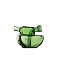 The MJ Arsenal Commander Blunt Bubbler is a modern green borosilicate glass vessel with a rounded base and two angled tubular spouts, resembling a mini bubbler and shown on a plain white background.