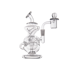 The MJ Arsenal Infinity Mini Dab Rig, made of clear borosilicate glass, features intricate curves, a round base, angled mouthpiece, and side banger attachment, shown against a plain white background.