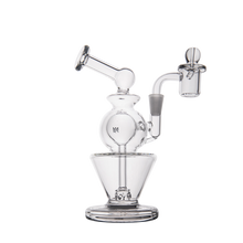 The MJ Arsenal Gemini Mini Dab Rig, made from clear borosilicate glass, features a round chamber, angled mouthpiece, and attached bowl. This portable water pipe is shown against a plain white background.