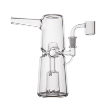 The MJ Arsenal Turret Mini Dab Rig, made of clear borosilicate glass with a cylindrical base, vertical chamber, side arm, and quartz banger, is shown photographed on a white background.