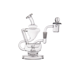 The MJ Arsenal Claude Mini Dab Rig is a clear glass recycler with multiple chambers, a bent neck, round base, and quartz banger on the right, shown on a white background.