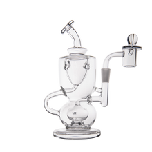 The MJ Arsenal Titan Mini Dab Rig is a clear borosilicate glass piece featuring intricate, curved tubes and a side chamber, displayed against a plain white background.