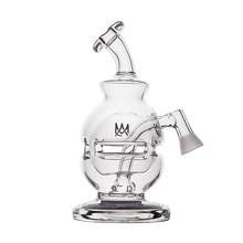 The MJ Arsenal Royale Vape Edition is a clear glass dab rig featuring a curved neck, wide round chamber, flat base, an etched crown logo on the front, and a slanted side joint for easy bowl attachment.