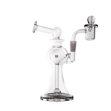 The MJ Arsenal Apollo Mini Dab Rig is a clear borosilicate glass piece featuring a round chamber, angled mouthpiece, and attached bowl, designed for optimal flavor when smoking or vaporizing. Shown on a plain white background.