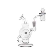 The MJ Arsenal Atlas Mini Dab Rig is a clear borosilicate glass water pipe with a spherical base, angled neck, side arm, and includes a glass bowl and dome attachment—photographed on white for compact, smooth sessions.