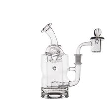 The MJ Arsenal Turbine Mini Dab Rig, made of clear borosilicate glass with a bent mouthpiece, cylindrical body, side handle, and domed quartz banger, sits on a white background—ideal for fans of this sleek design.
