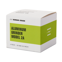 The modern, minimalist white and green box for the Human Grade Grinder 2A (2.5" 4-Piece) features a pollen screen and highlights its human-grade, four-piece aluminum design.