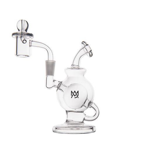 The MJ Arsenal Atlas Mini Dab Rig is a compact clear borosilicate glass rig with a round base, curved mouthpiece, side handle, removable dome and nail, and a black overlapping letter logo on the main chamber.