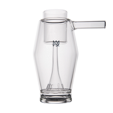 The MJ Arsenal Proxy Bubbler is a clear borosilicate glass piece featuring a cylindrical handle and a distinctive internal structure that runs from the base to just below the rim, shown against a white background.